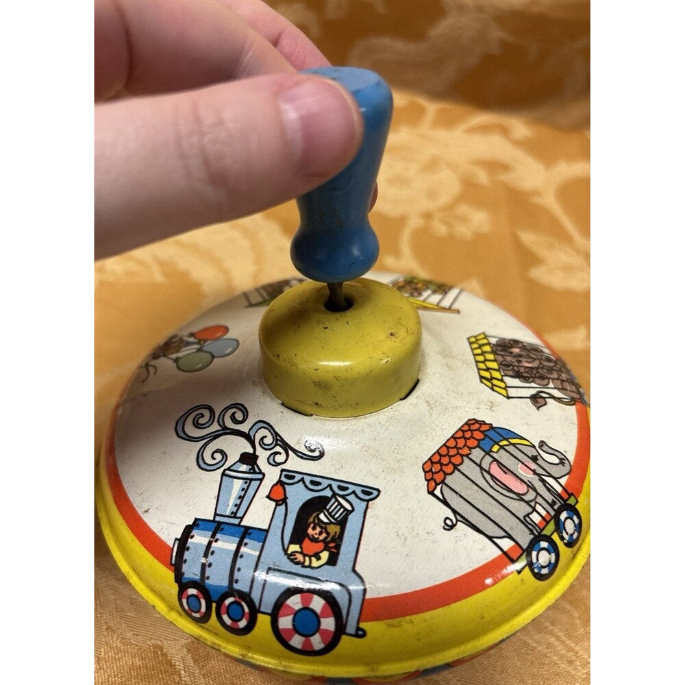 Vintage Ohio Art spinning top featuring a circus train design